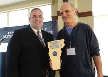 Vermont Emergency Management Director of the Year Nick Elem showing his award standing next to Vermont Public Safety Commissioner Dan Batsie